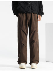 Brown drawstring sweatpants with a relaxed fit and unique paneling details.