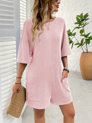 Blush pink ribbed knit romper with short sleeves, crew neck, and two front pockets.