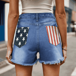 Distressed denim shorts with American flag pocket details and frayed hem.
