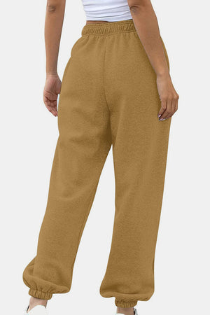 Slouchy sweatpants in tan with gathered cuffs and elastic waistband.
