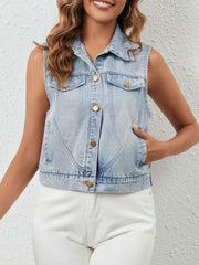 Cropped sleeveless light wash denim vest with button front and pockets.