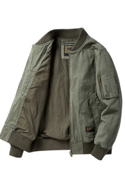 Army green bomber jacket with patch detail and zippered sleeve pocket.