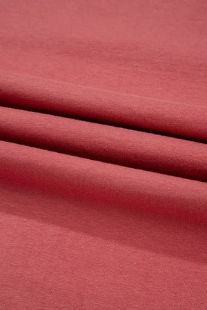 Burnt coral t-shirt fabric with a soft, textured knit detail