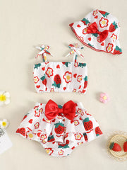 Baby strawberry print set with ruffled bloomers, tie-strap top, and bucket hat with red bow.