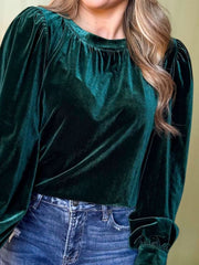 Dark green velvet blouse with ruched neckline and puff sleeves.