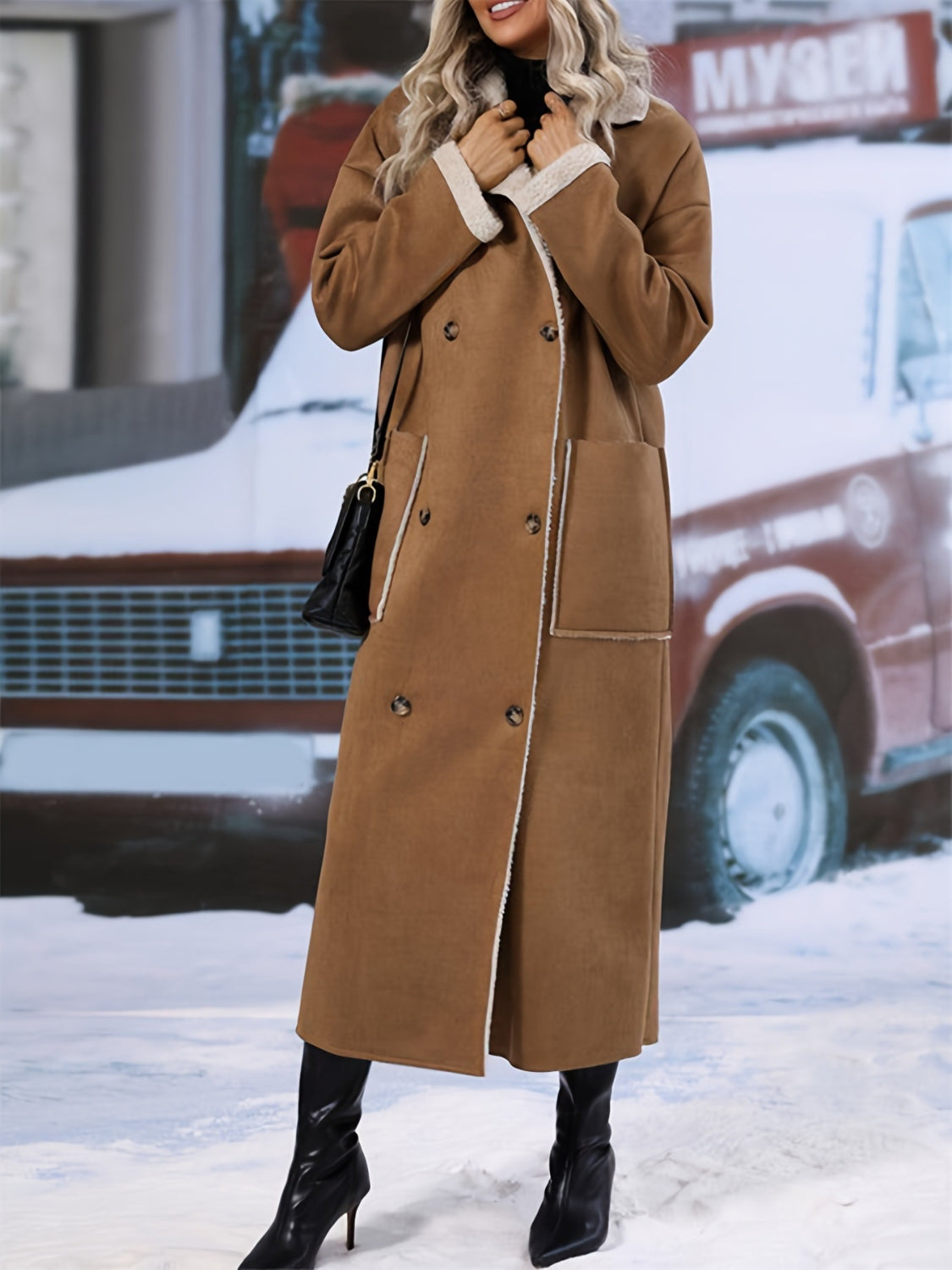 Brown reversible maxi coat with shearling trim and double-breasted closure.