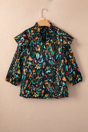 Black abstract print blouse with ruffled aura sleeves and a mock neck.