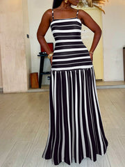 Plus size black and white striped maxi dress with a fitted bodice and flared skirt.