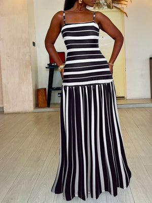 Plus size black and white striped maxi dress with a fitted bodice and flared skirt.