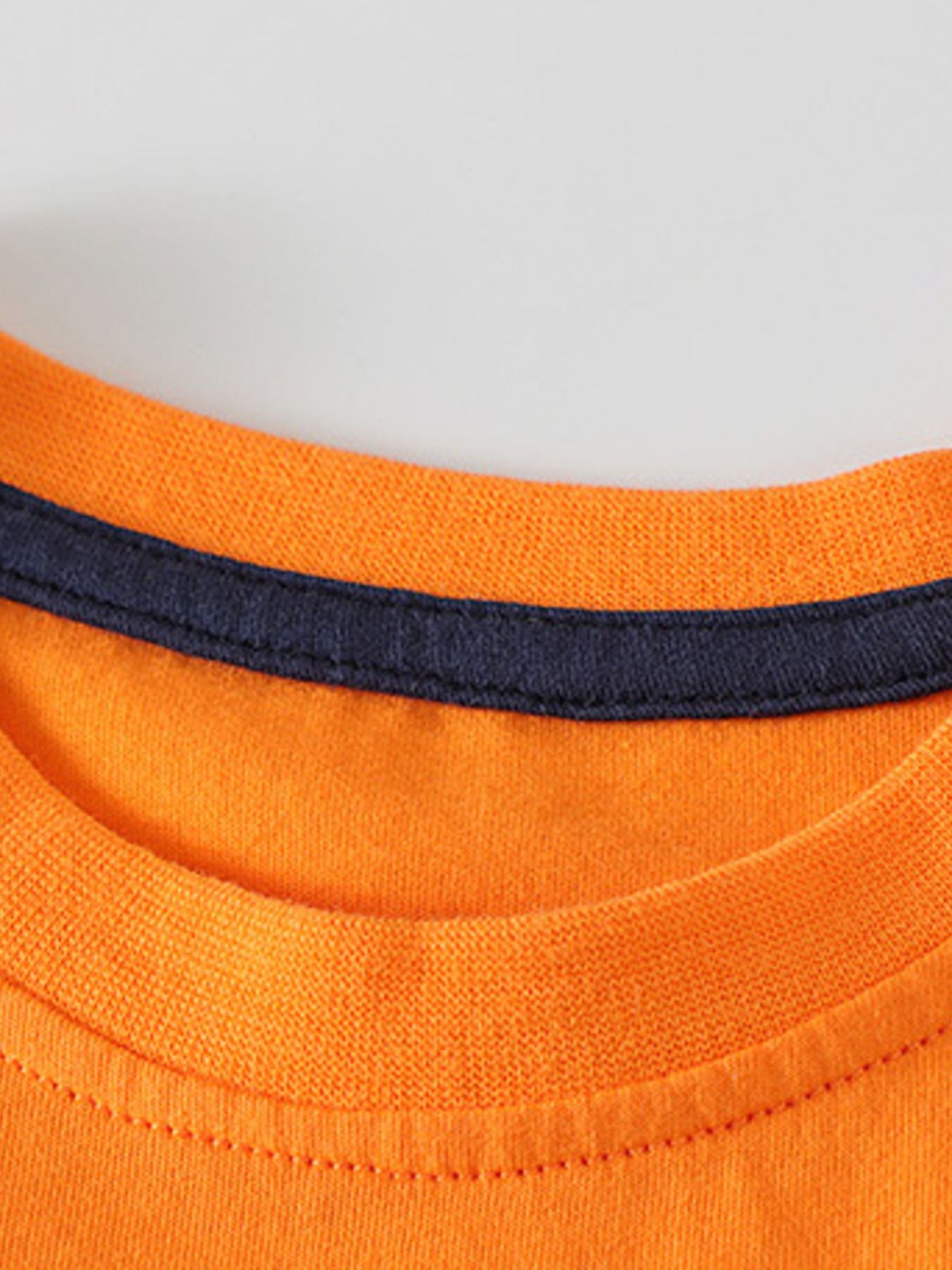 Toddler orange cotton graphic tee with navy trim at neckline