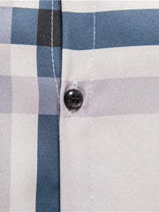 Men's blue plaid cotton button-up shirt with a dark button detail.