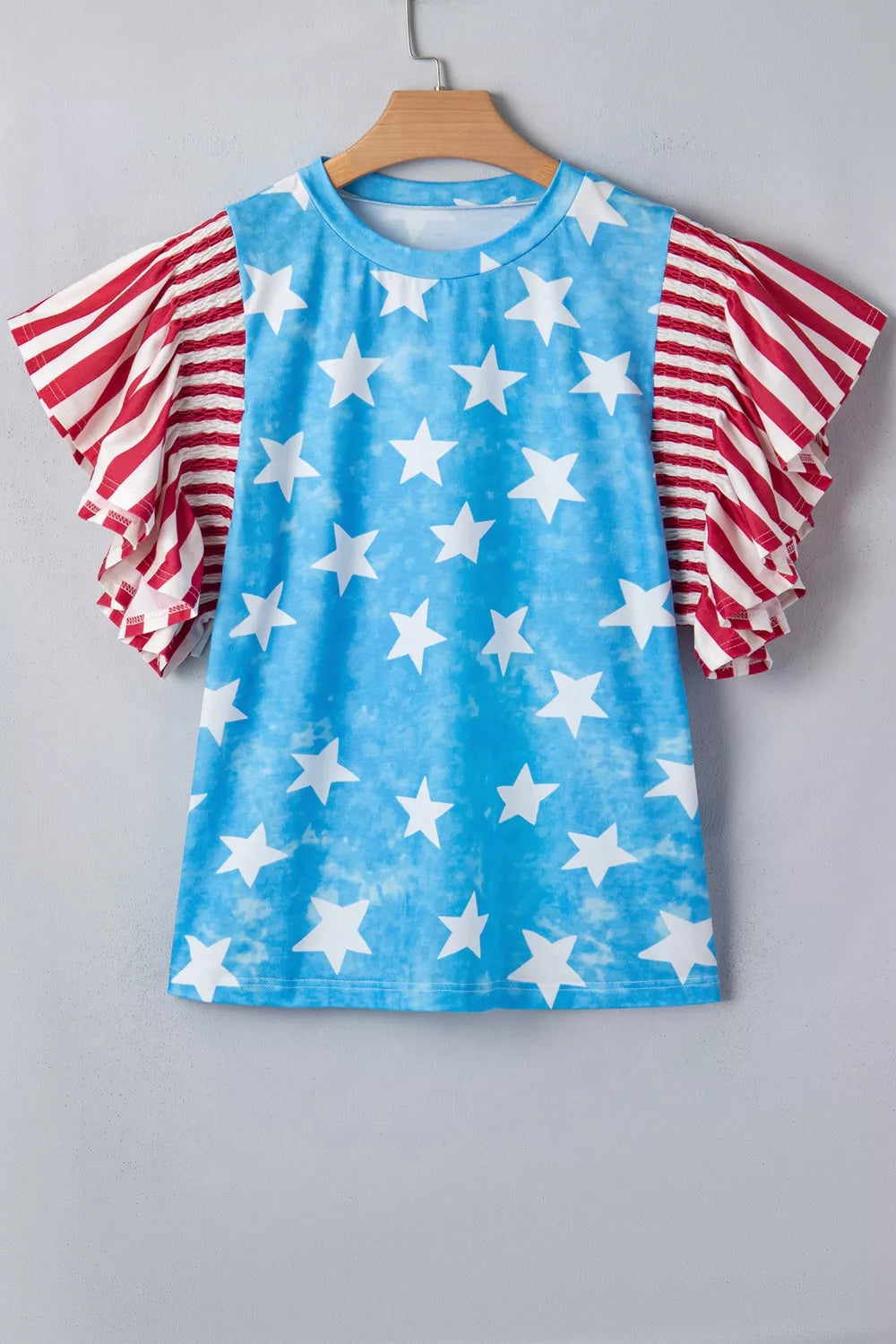 Patriotic t-shirt with blue star print and red striped ruffle sleeves.