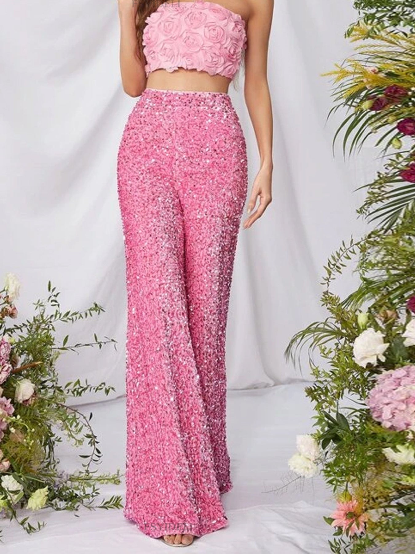 Pink sequin wide leg pants with a high waist and flowy silhouette.
