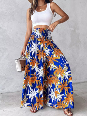 Bohemian print wide leg pants in Royal Blue with smocked waist and palm tree pattern.