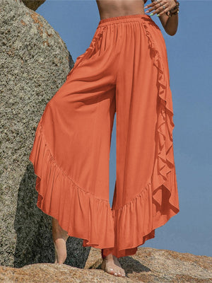 Ochre palazzo pants with ruffled hemline and split legs, styled for a boho chic look.
