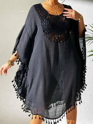 Black kaftan dress with crochet yoke and tassel trim.