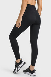 Black performance leggings with pockets and a sculpted waistband.