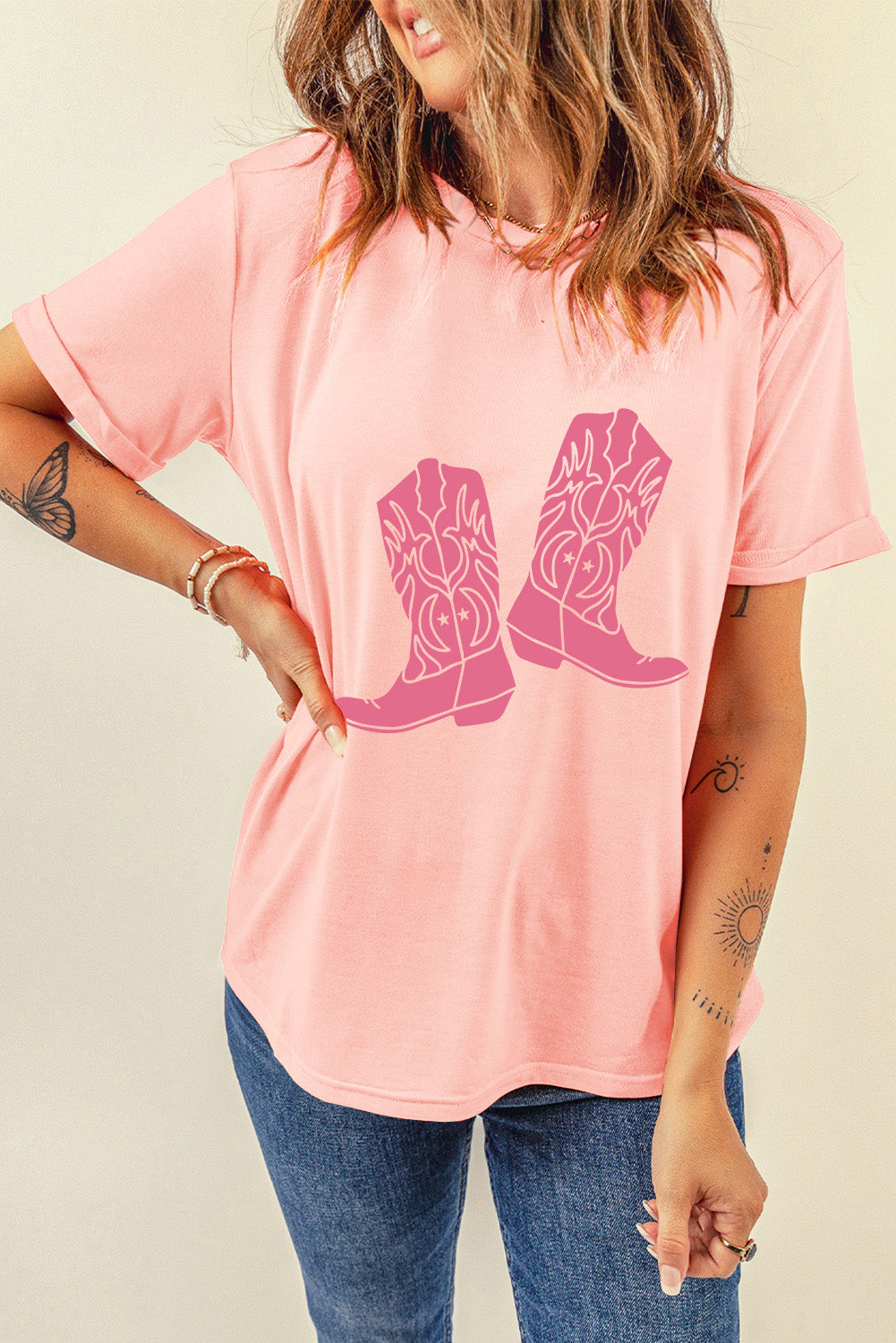 Graphic round neck tee in blush pink with a pink cowboy boot graphic and cuffed sleeves.