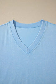 Light blue cotton v-neck top with relaxed fit and double-stitched neckline detail.