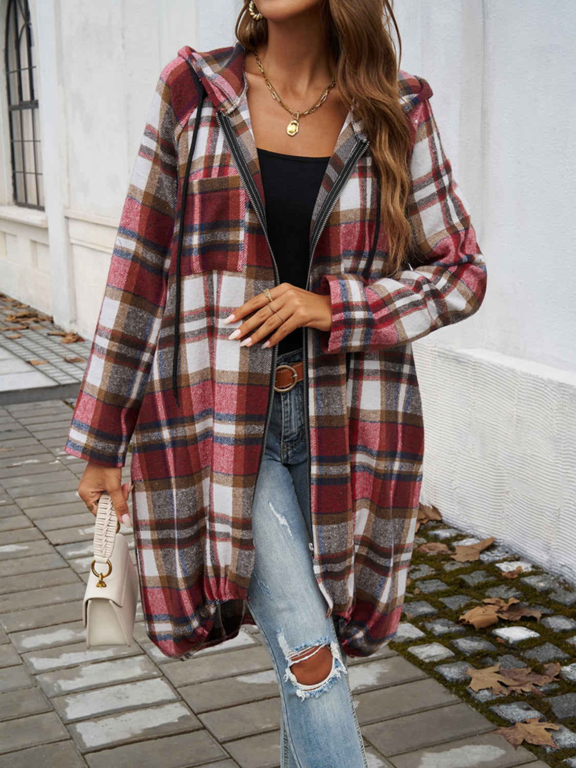 Draped plaid cocoon hoodie jacket in red and brown plaid with a zipper and drawstring hood.
