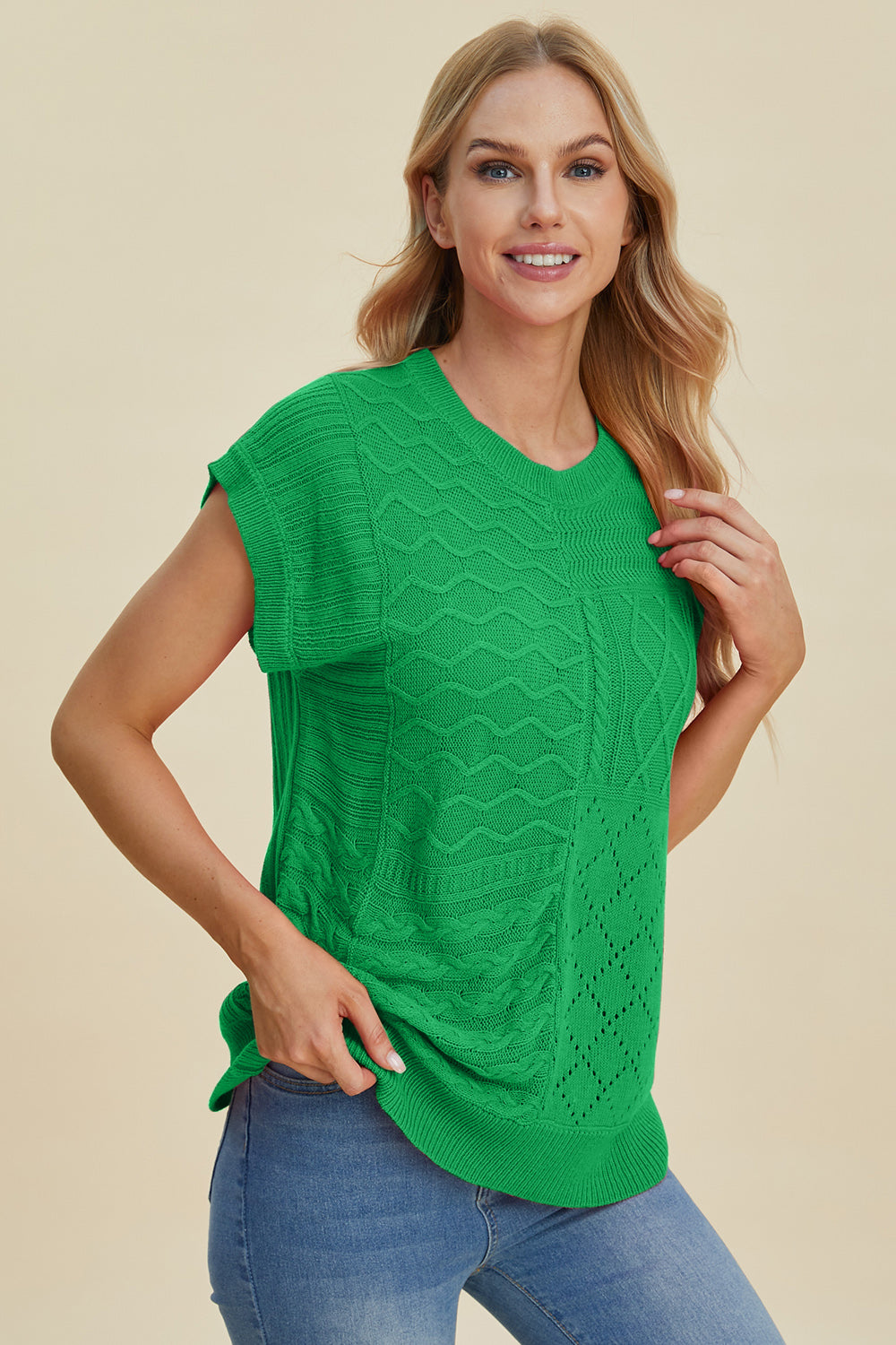 Green knit patchwork top with cable and diamond stitch details, short sleeves.