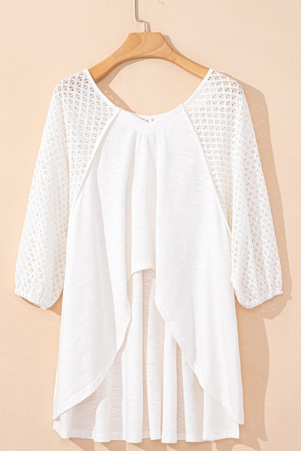 White lace-inset dolman sleeve blouse with a flowing hemline.