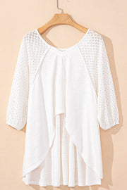 White lace-inset dolman sleeve blouse with a flowing hemline.