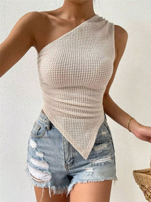 Asymmetrical waffle knit tank top in apricot with a one-shoulder design.