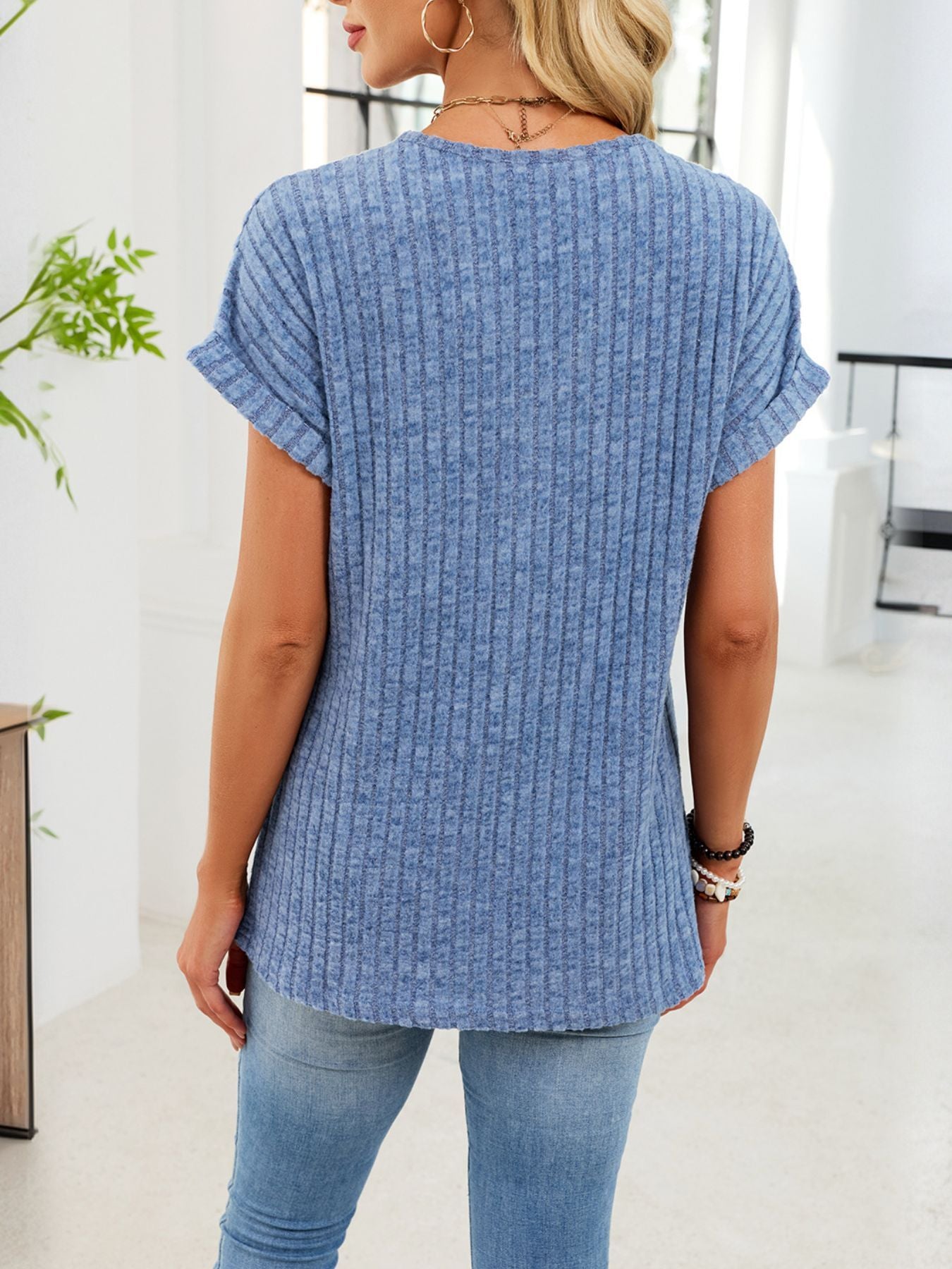 Light blue ribbed knit v-neck t-shirt with cuffed short sleeves and buttons.