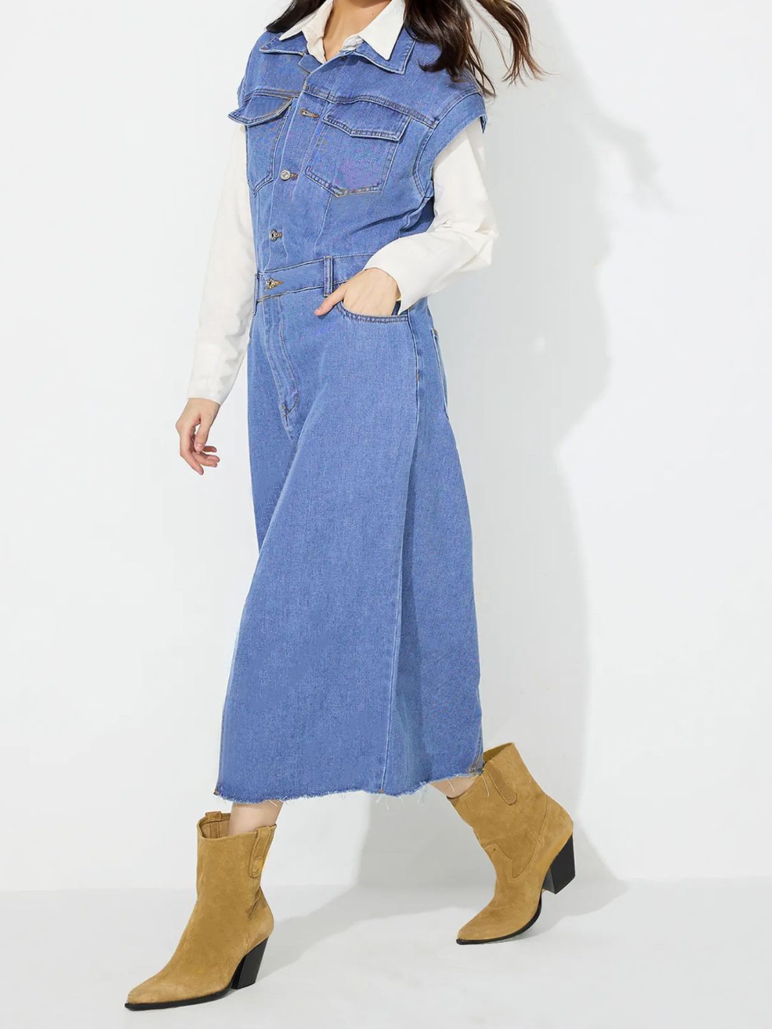Sleeveless denim midi dress in medium wash with button details and a side slit.