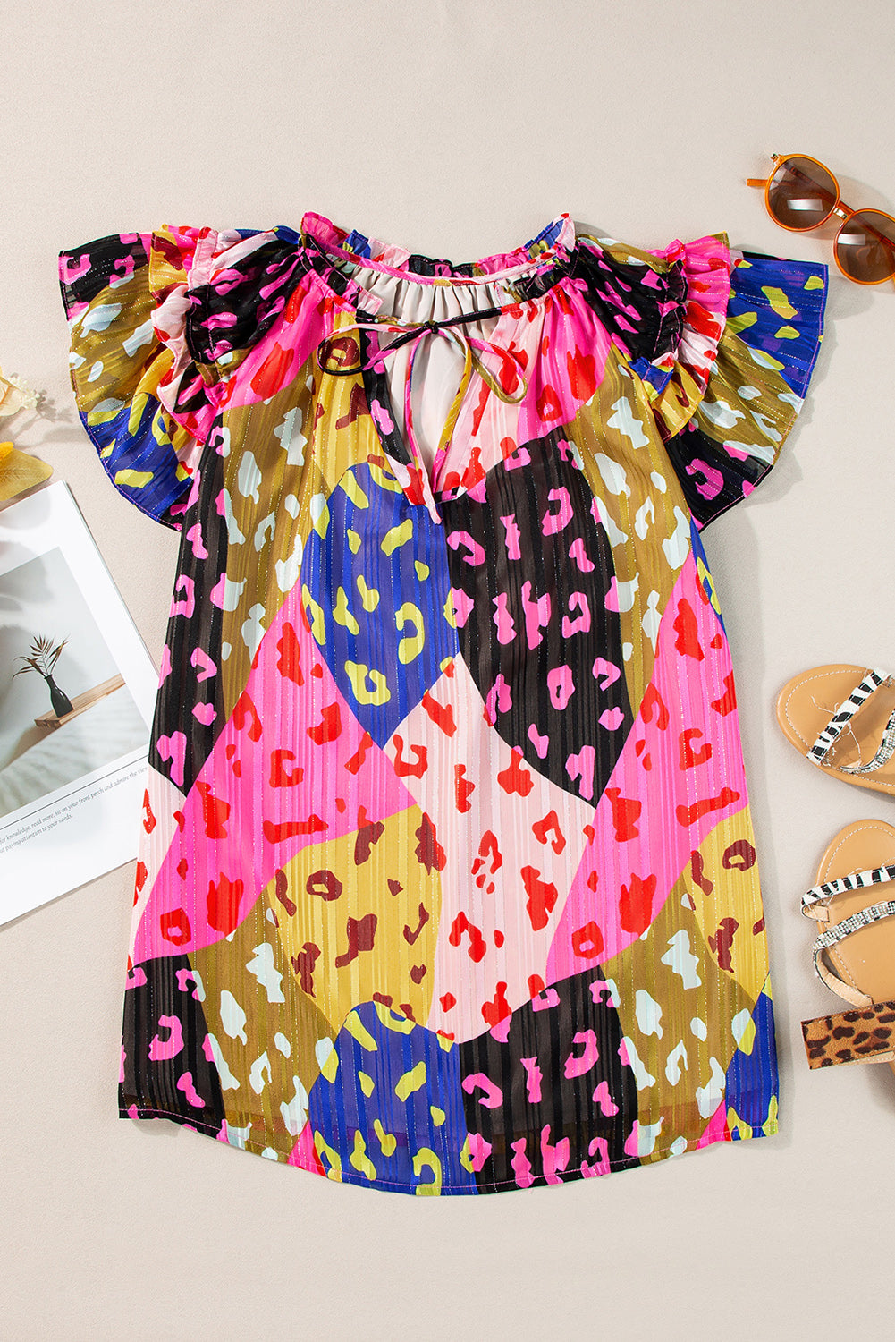 Floral patchwork blouse with ruffle sleeves and tie neck, featuring leopard print accents in hot pink and neon green colors.