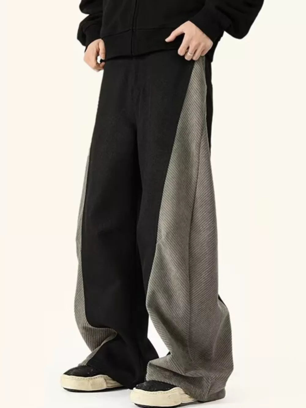 Men's black sweatpants with grey contrast panels and relaxed fit