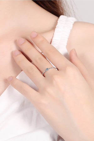 Delicate silver band ring with small diamonds and scalloped details.