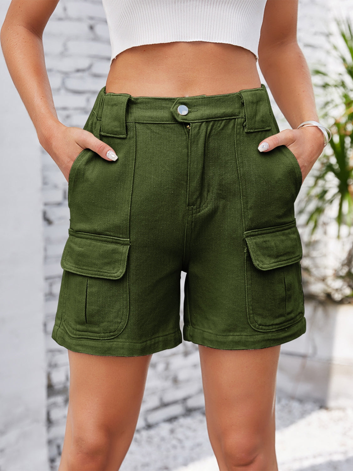 Army green denim cargo shorts with utility pockets and a high waist.