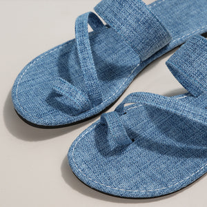 Light blue crisscross toe loop sandals with white stitching detail.