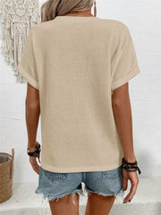 Apricot waffle knit V-neck t-shirt with cuffed short sleeves.