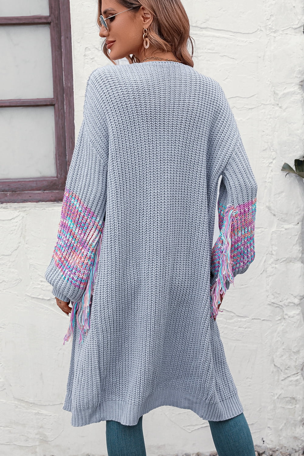 Cloudy Blue acrylic cardigan with textured sleeves and colorful fringe detail.