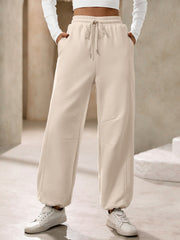 Tan balloon-leg sweatpants with drawstring waist and pockets