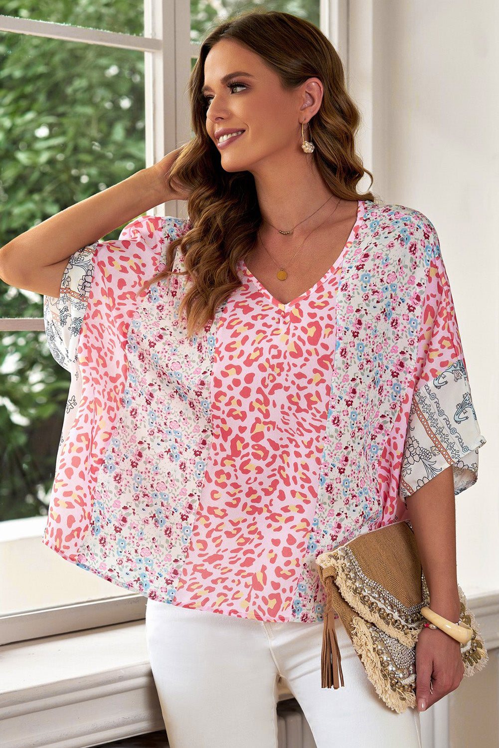 Panel print kimono sleeve blouse in floral pattern with V-neck and relaxed fit.