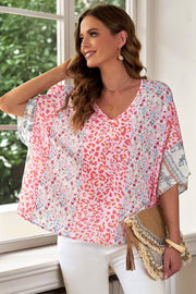 Panel print kimono sleeve blouse in floral pattern with V-neck and relaxed fit.