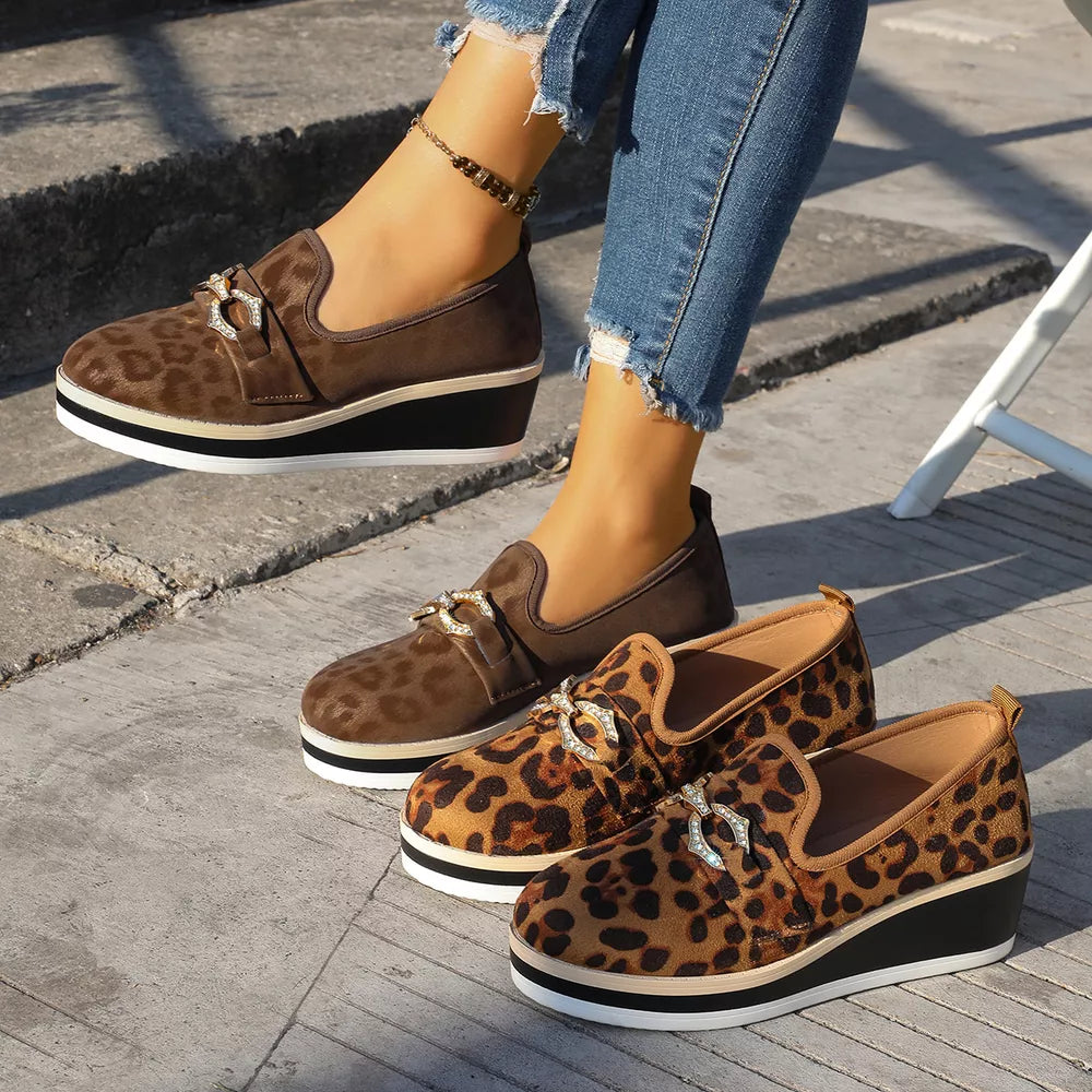 Leopard print wedge loafers with buckle detail in brown and black.