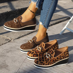 Leopard print wedge loafers with buckle detail in brown and black.