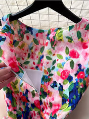 Vibrant floral midi dress with a pleated skirt and zipper detail.