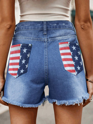 Distressed denim shorts with American flag pocket details and frayed hem.