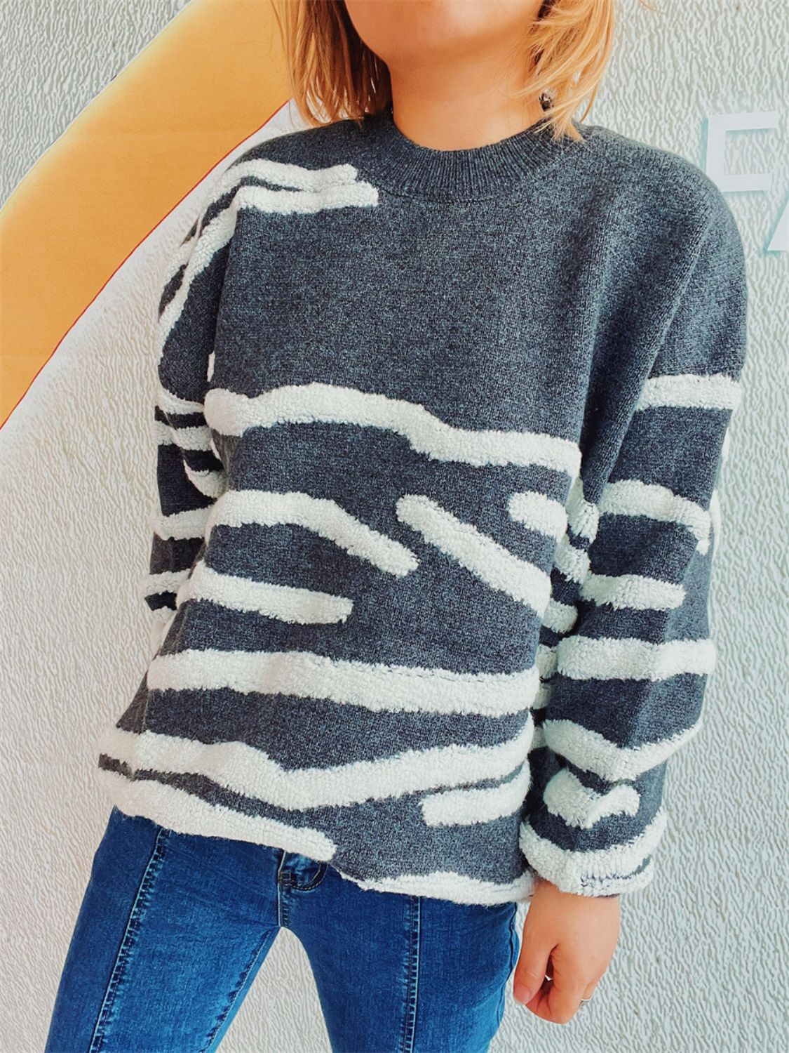Textured stripe knit crewneck sweater in dark gray with white fuzzy stripes.