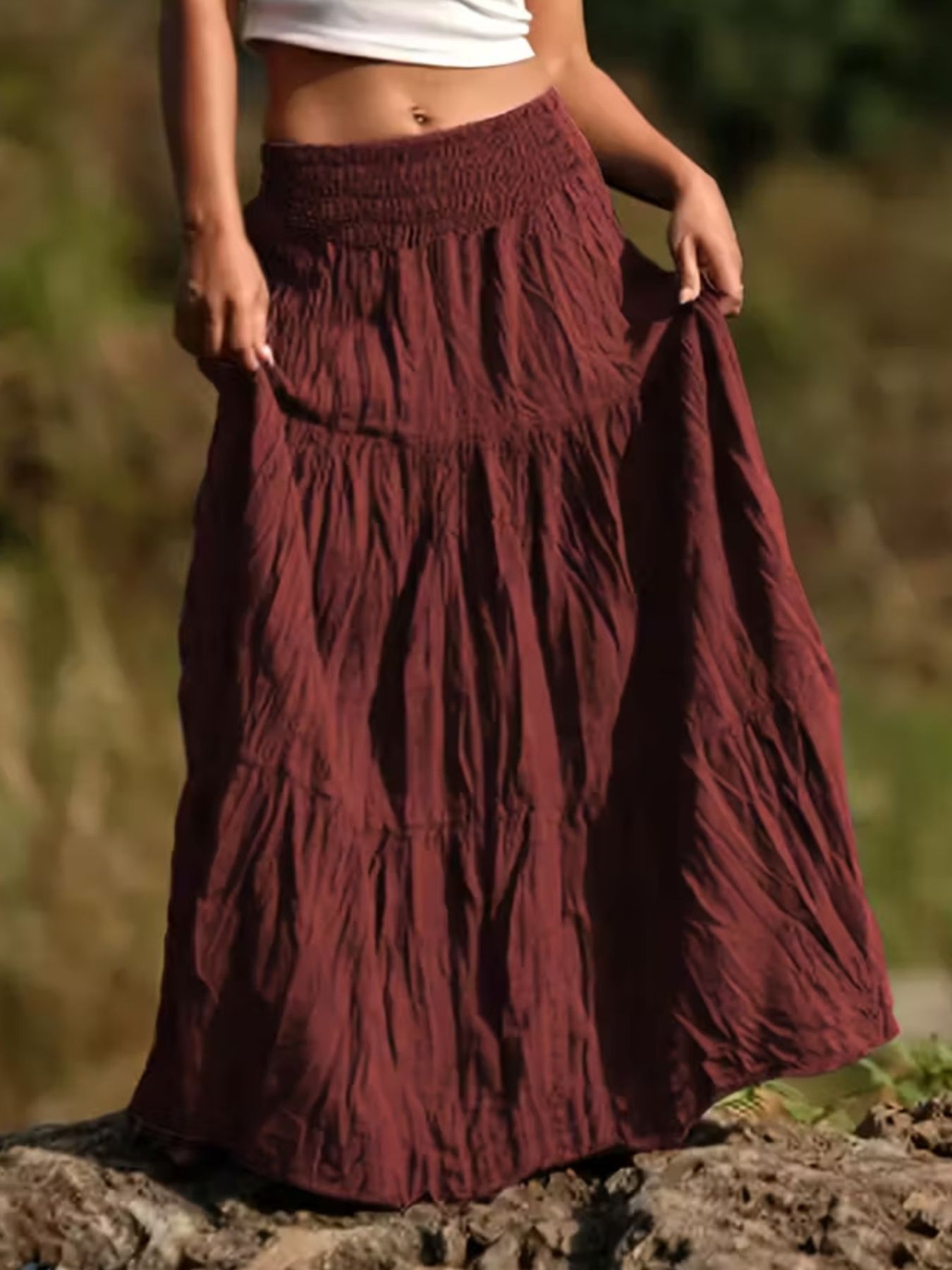Burgundy tiered maxi skirt with smocked waist and crinkled fabric detail.