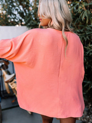 Textured sleeve blouse in burnt coral with elastic cuffs.