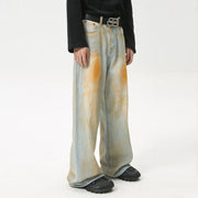 Acid wash palazzo denim jeans in light blue with orange splatters and a wide leg.