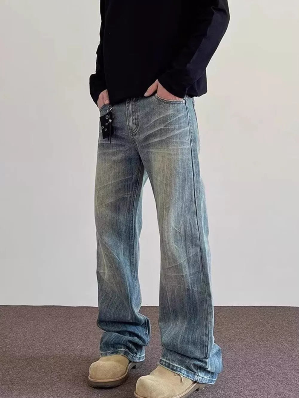 Men's vintage wash blue cotton wide leg jeans with a relaxed fit.