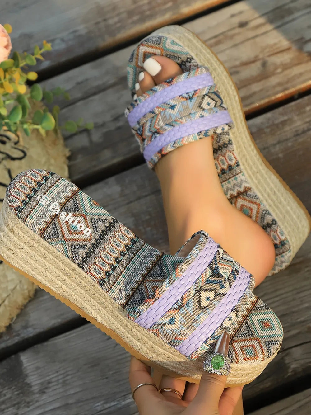 Woven platform slides in lavender with geometric pattern and espadrille sole.